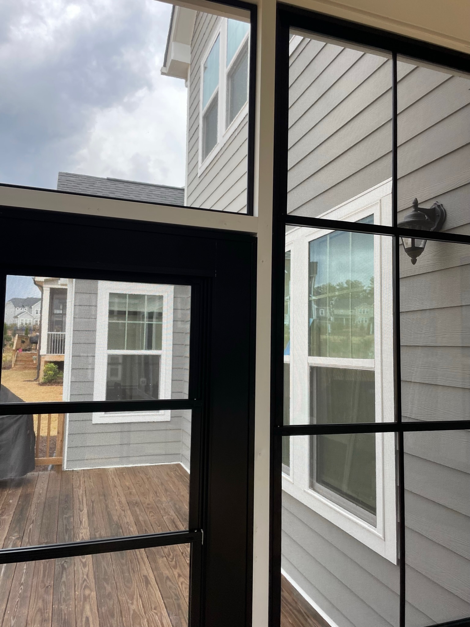 Interior view of white Eze-Breeze 4V60 vertical sliders mounted from the porch side.