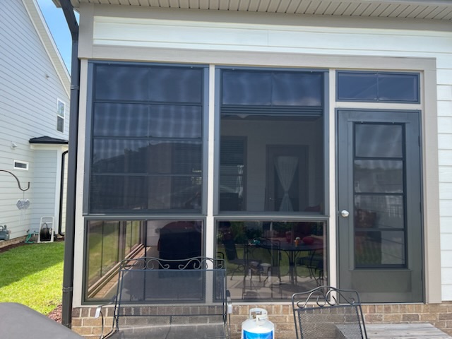 Exterior view of Eze-Breeze 4V60 vertical sliders mounted across the outside face of porch openings.