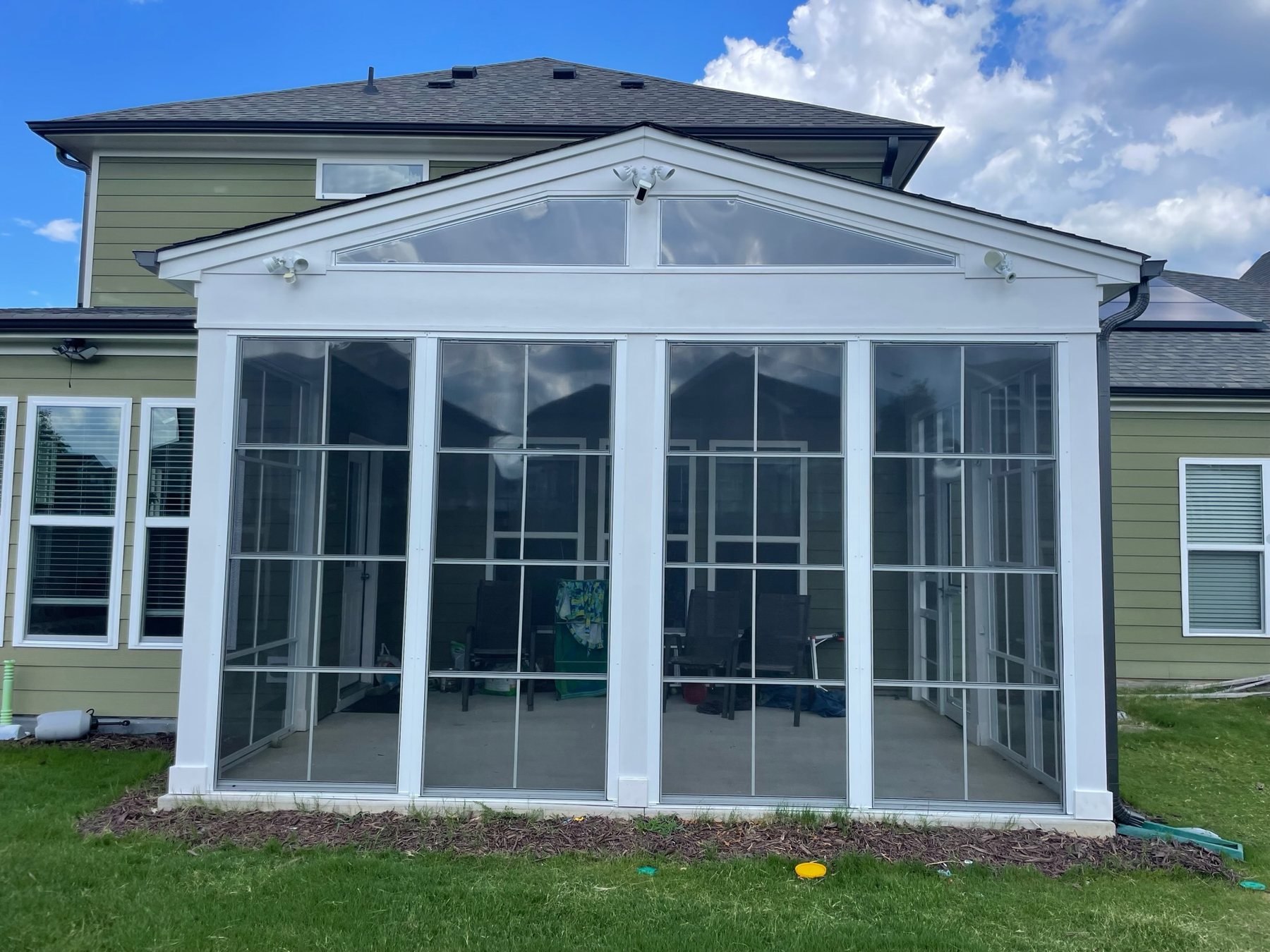 White Eze-Breeze 4V60 vertical-slider porch enclosure completed by Best Screens in Apex, North Carolina.