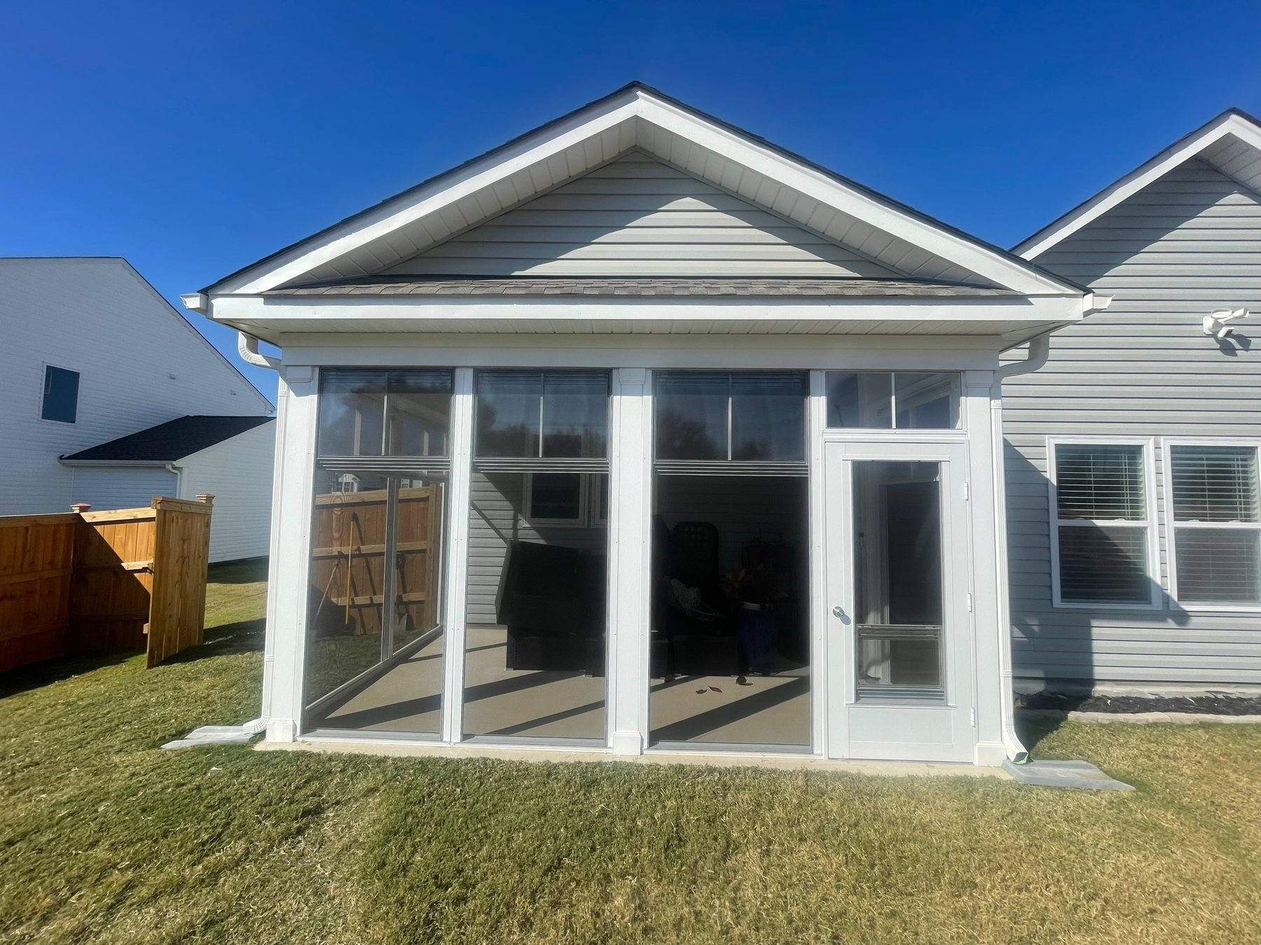 White Eze-Breeze 4V60 vertical-slider porch enclosure completed by Best Screens in Lillington, North Carolina.