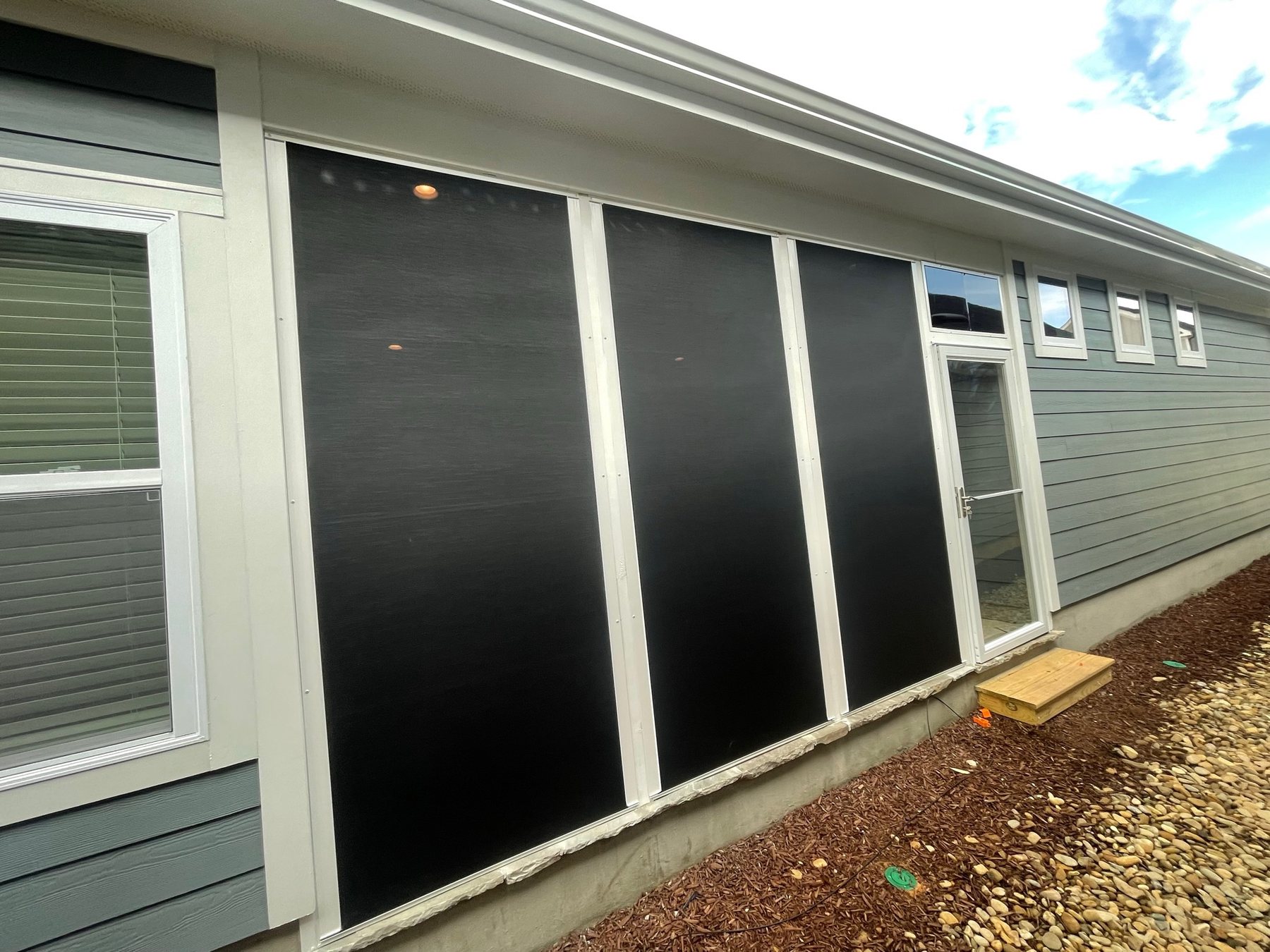 White Eze-Breeze 4V60 vertical-slider porch enclosure completed by Best Screens in Wendell, North Carolina.