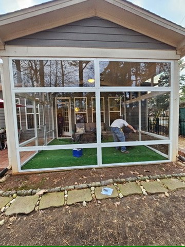 Front exterior view of a white CWS clear acrylic porch enclosure in Fuquay-Varina, North Carolina.