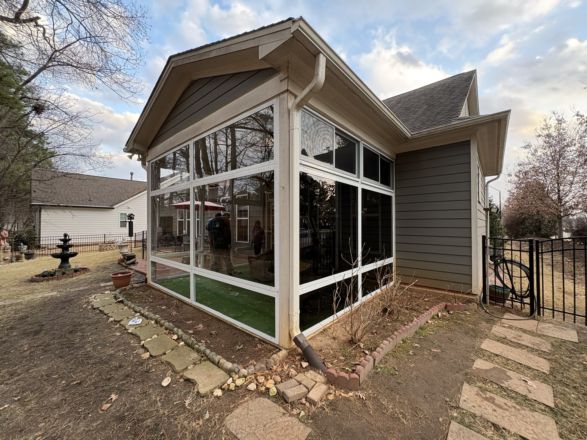 CWS clear acrylic porch enclosure with white aluminum frames, fixed panels and upper horizontal sliders in Fuquay-Varina, North Carolina.