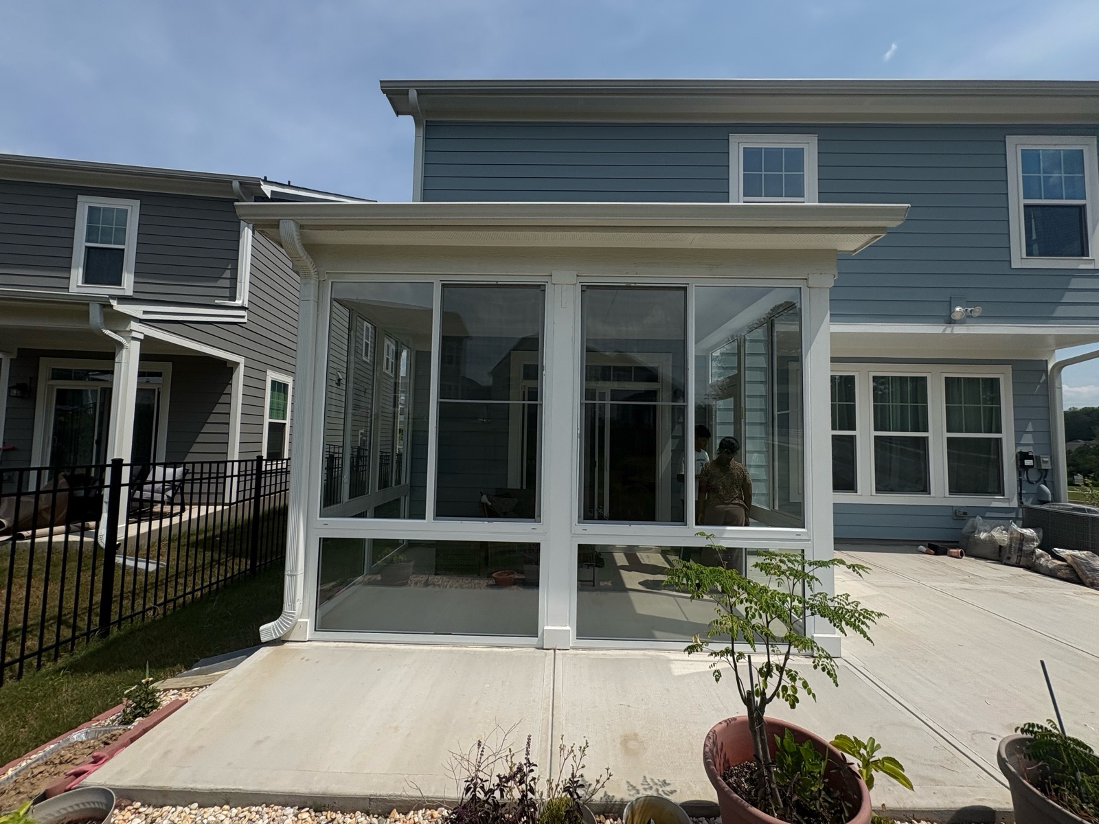 White CWS porch enclosure with single-pane clear side-sliding windows above fixed glass panels.