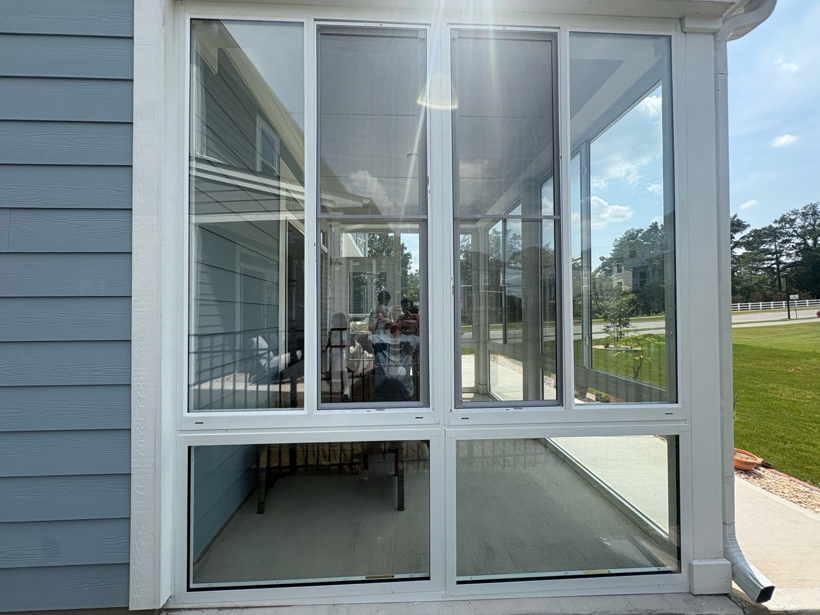 Close view of white CWS clear-glass side sliders above fixed single-pane panels.