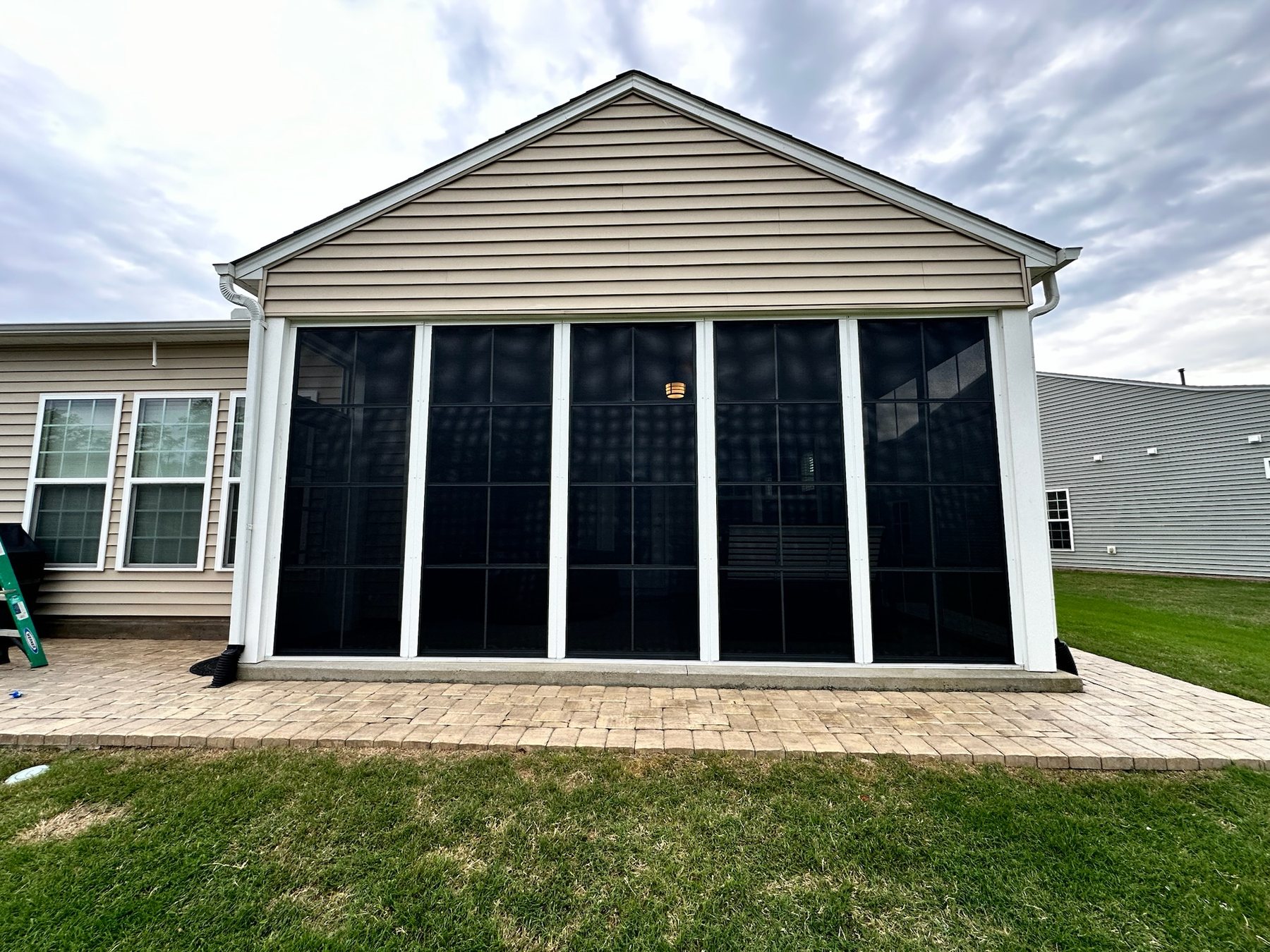 White Eze-Breeze 4V60 vertical-slider porch enclosure completed by Best Screens in Fuquay-Varina, North Carolina.