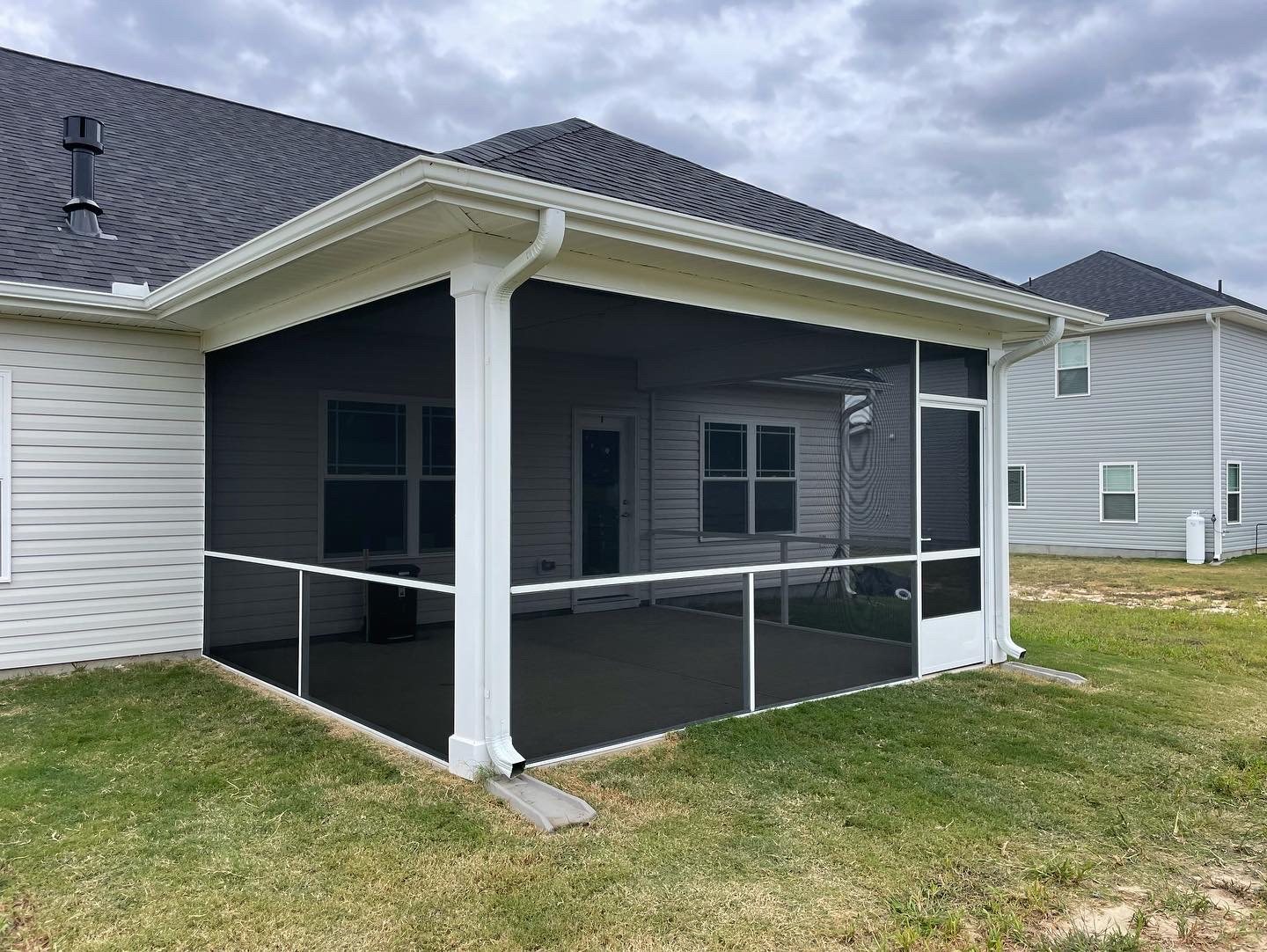 White extruded-aluminum screening wrapped around a covered porch corner.