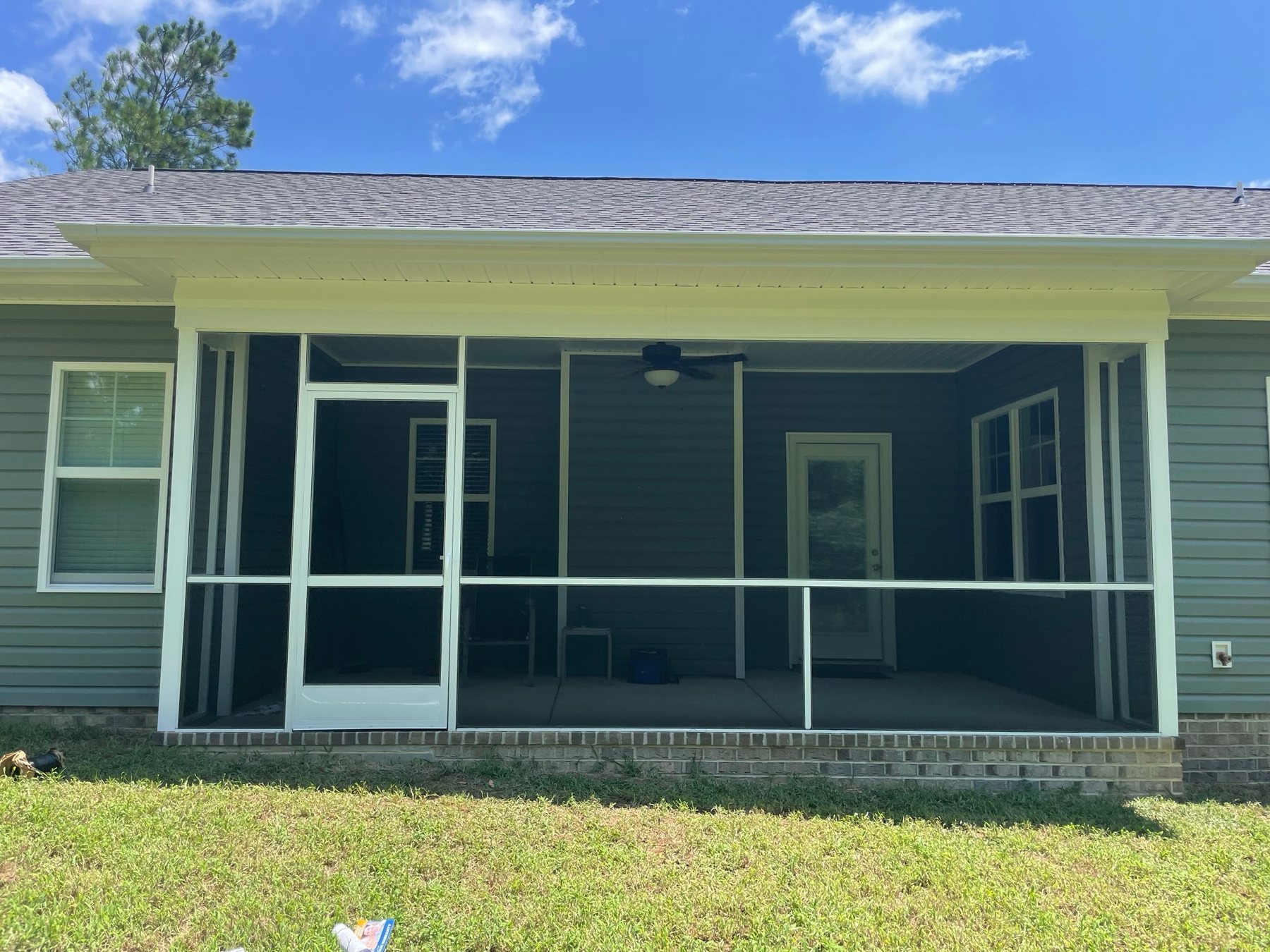 White PCA aluminum screen door installed in a custom screened porch enclosure.