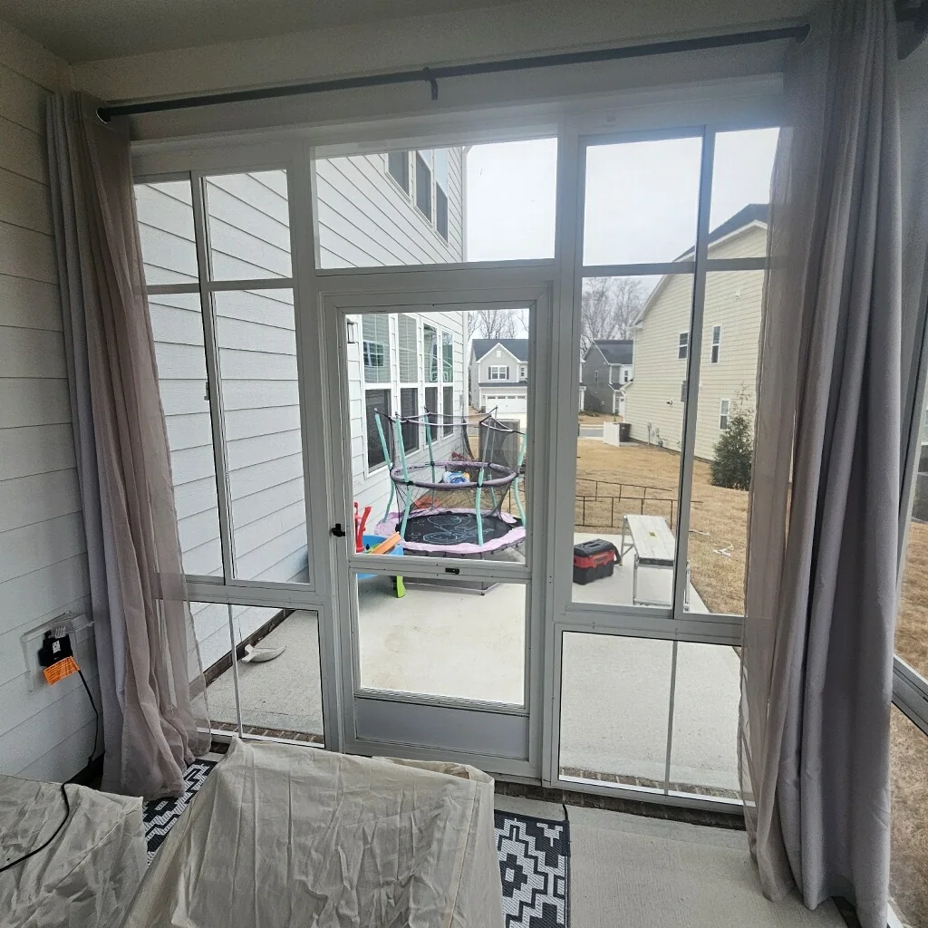 Interior view through an above-the-rail Eze-Breeze porch enclosure with one horizontal spreader bar.