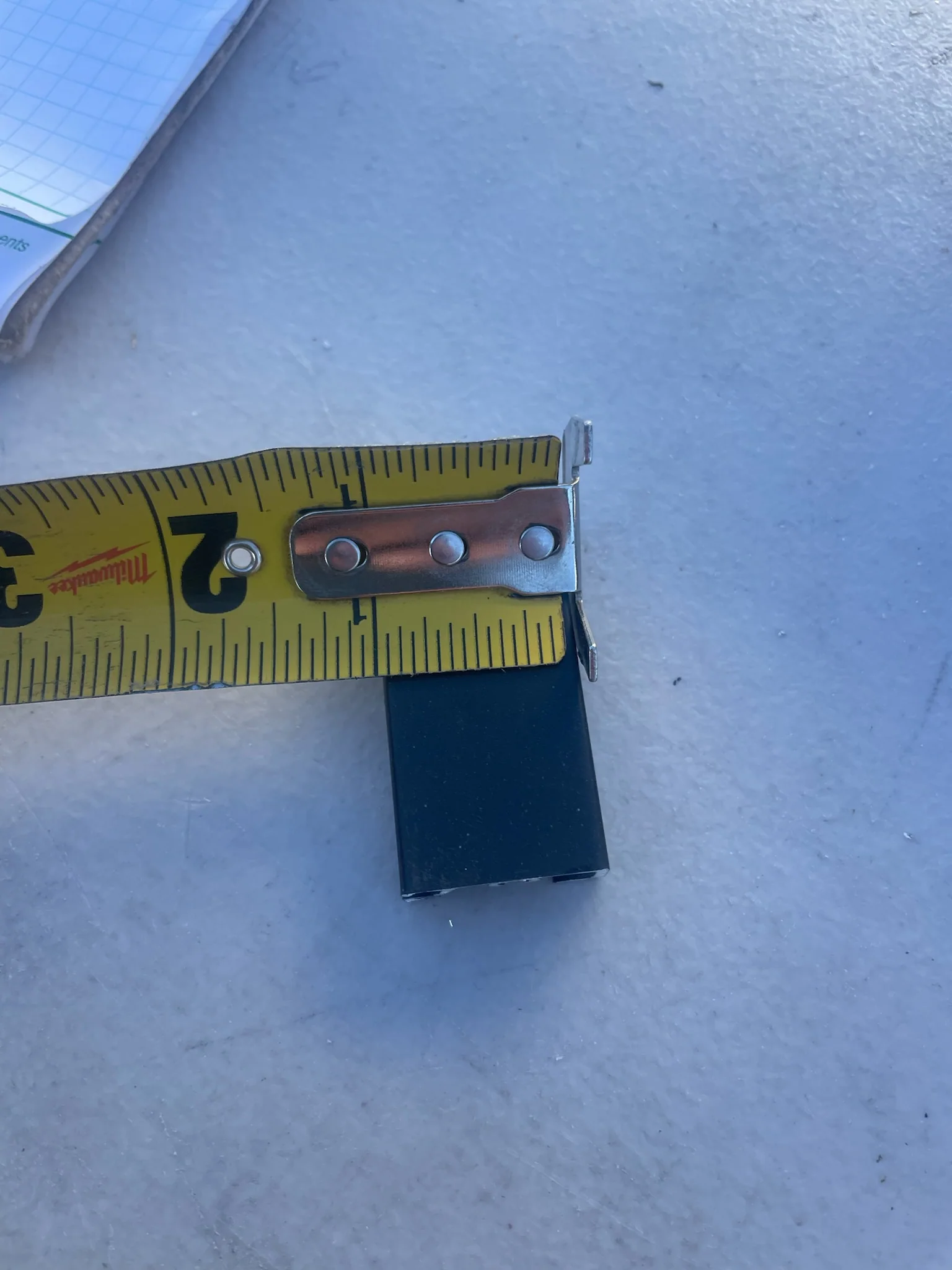 Tape measure across the approximately 1-inch face of black ARC aluminum.