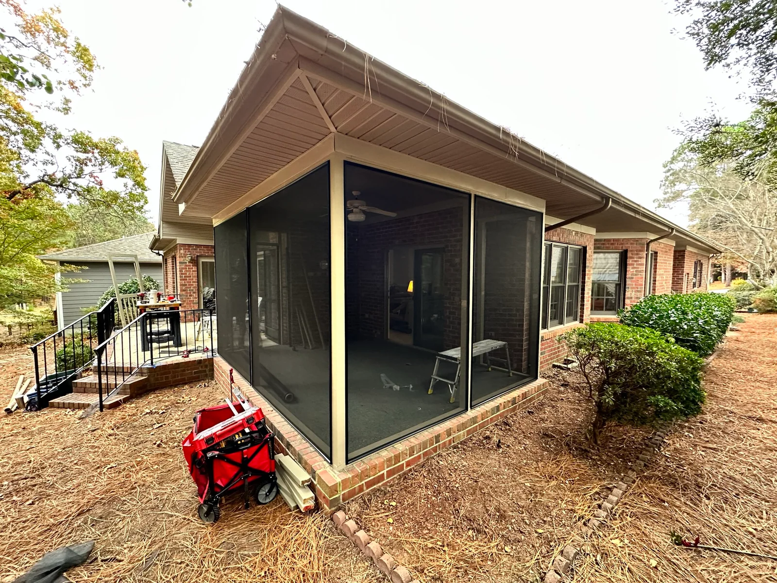 Southern Pines porch with bronze and black SCREENEZE framing and standard mesh.