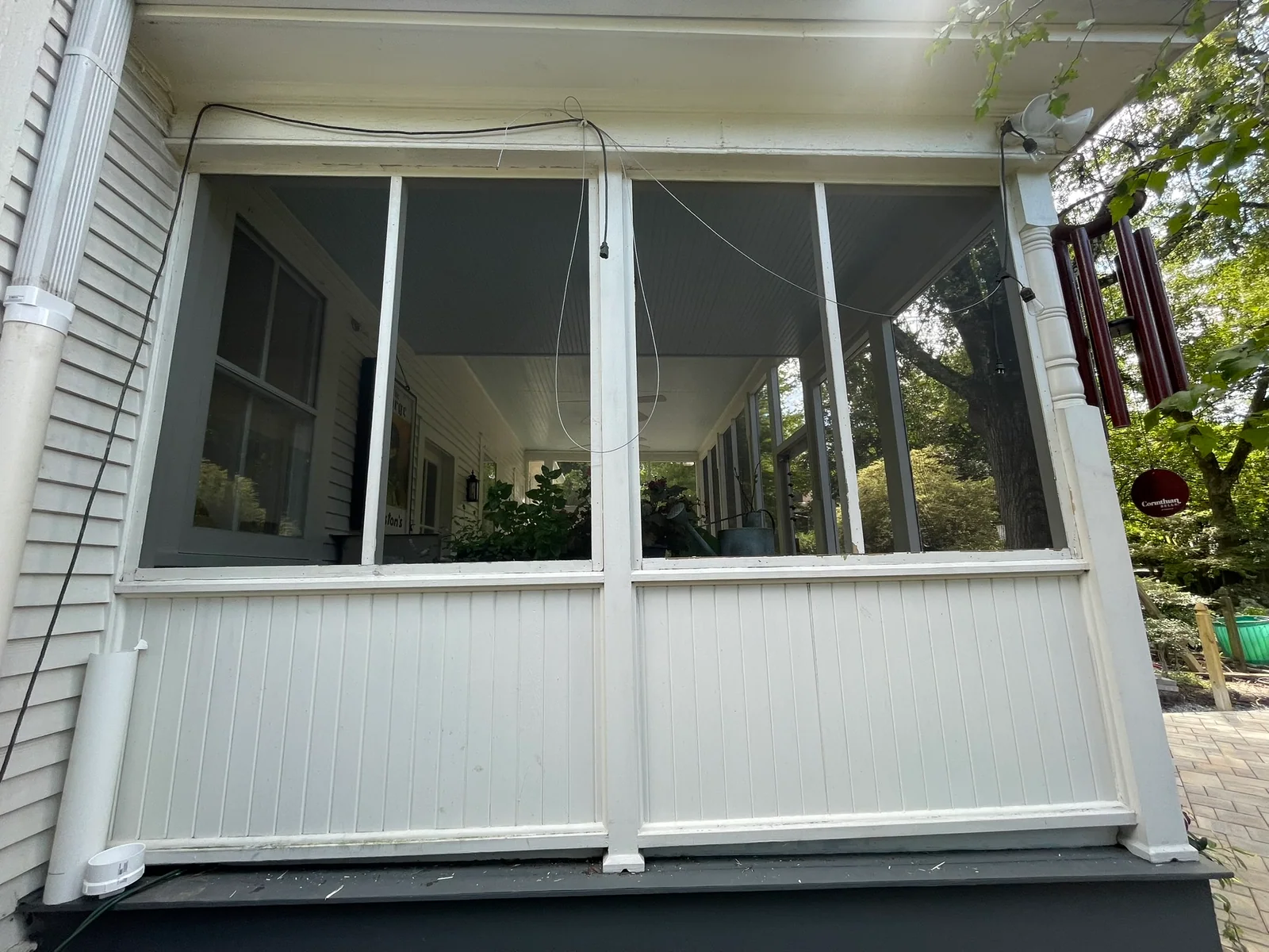 Greensboro wood porch screened with stapled standard mesh.