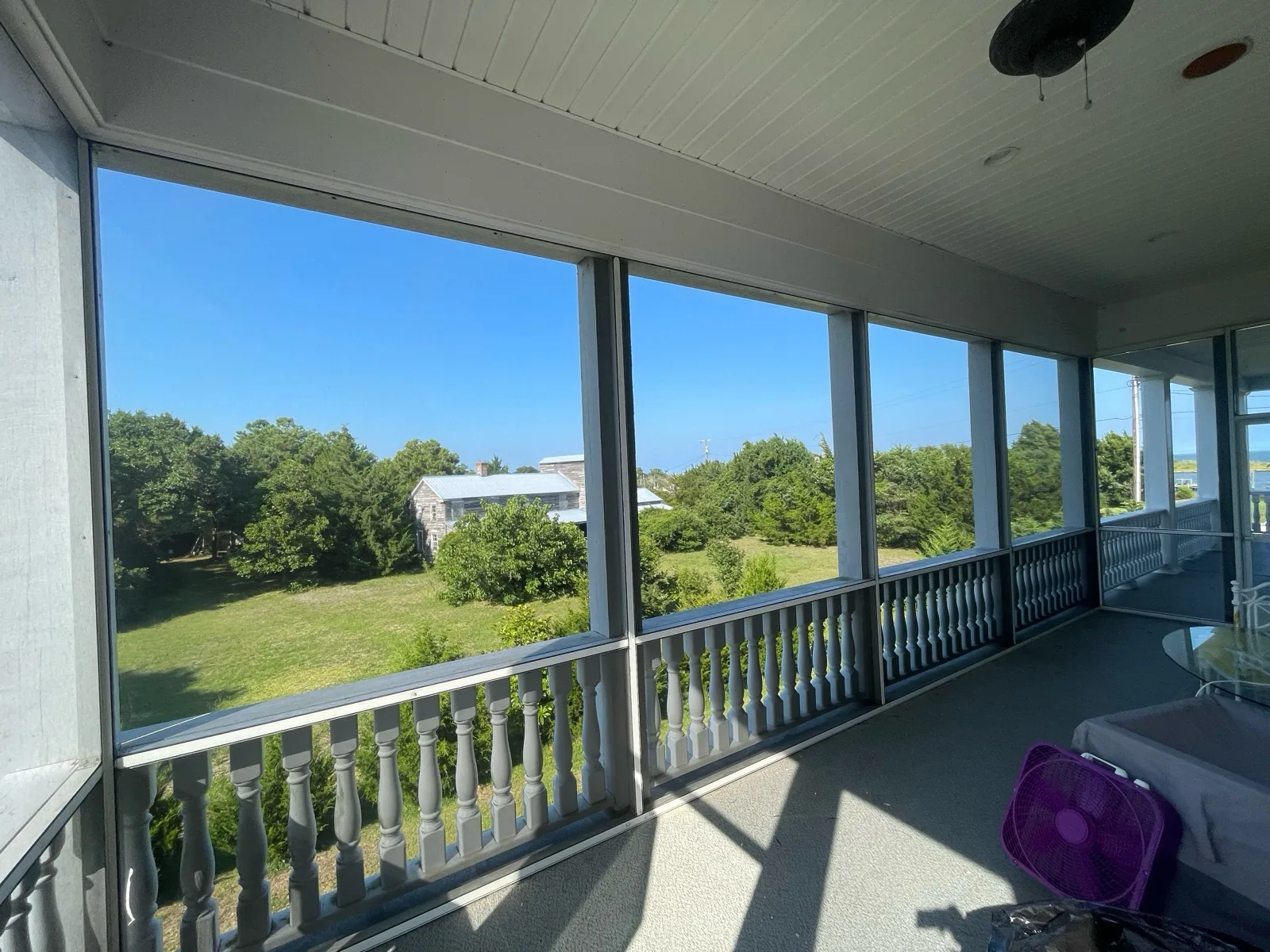 TuffScreen installed in a white extruded-aluminum porch enclosure.