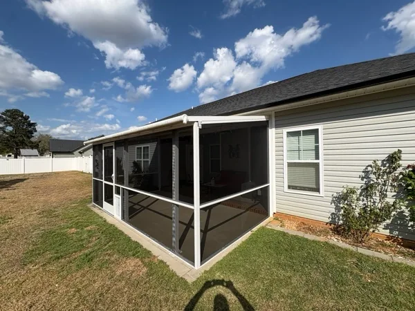 TuffScreen No-See-Um installed in white extruded-aluminum framing with a rail, PCA Zeus door, and pet door.