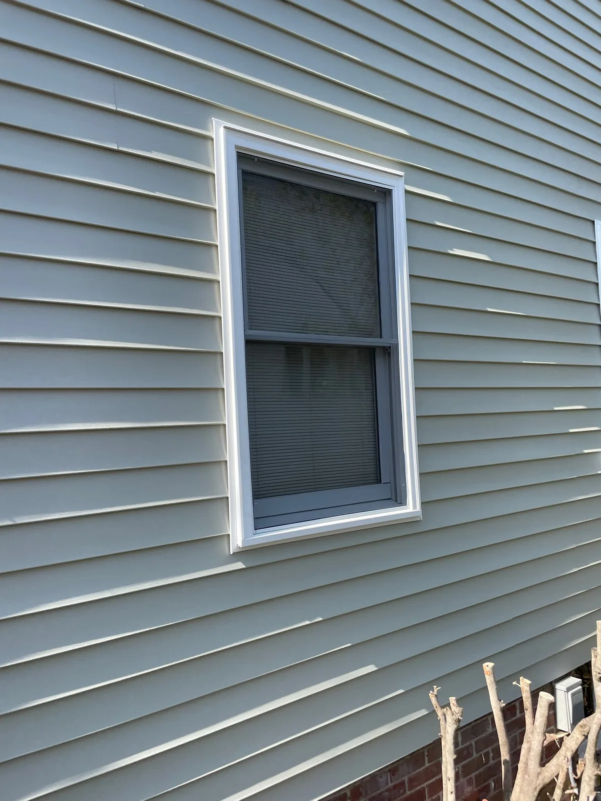 Installed full window screen in a residential window opening.