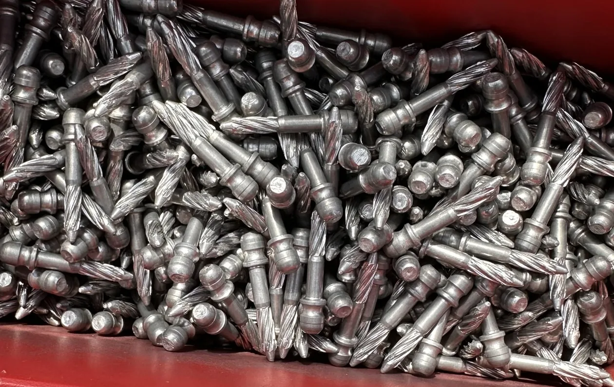 Metal ball-head screws used as sill anchors for older full window-screen latches.