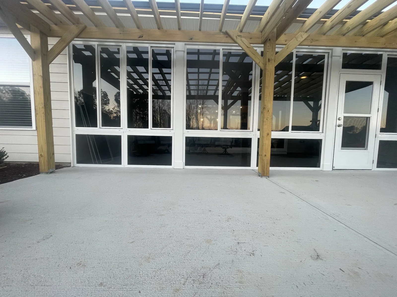White-framed CWS porch enclosure with gray-tinted glass.