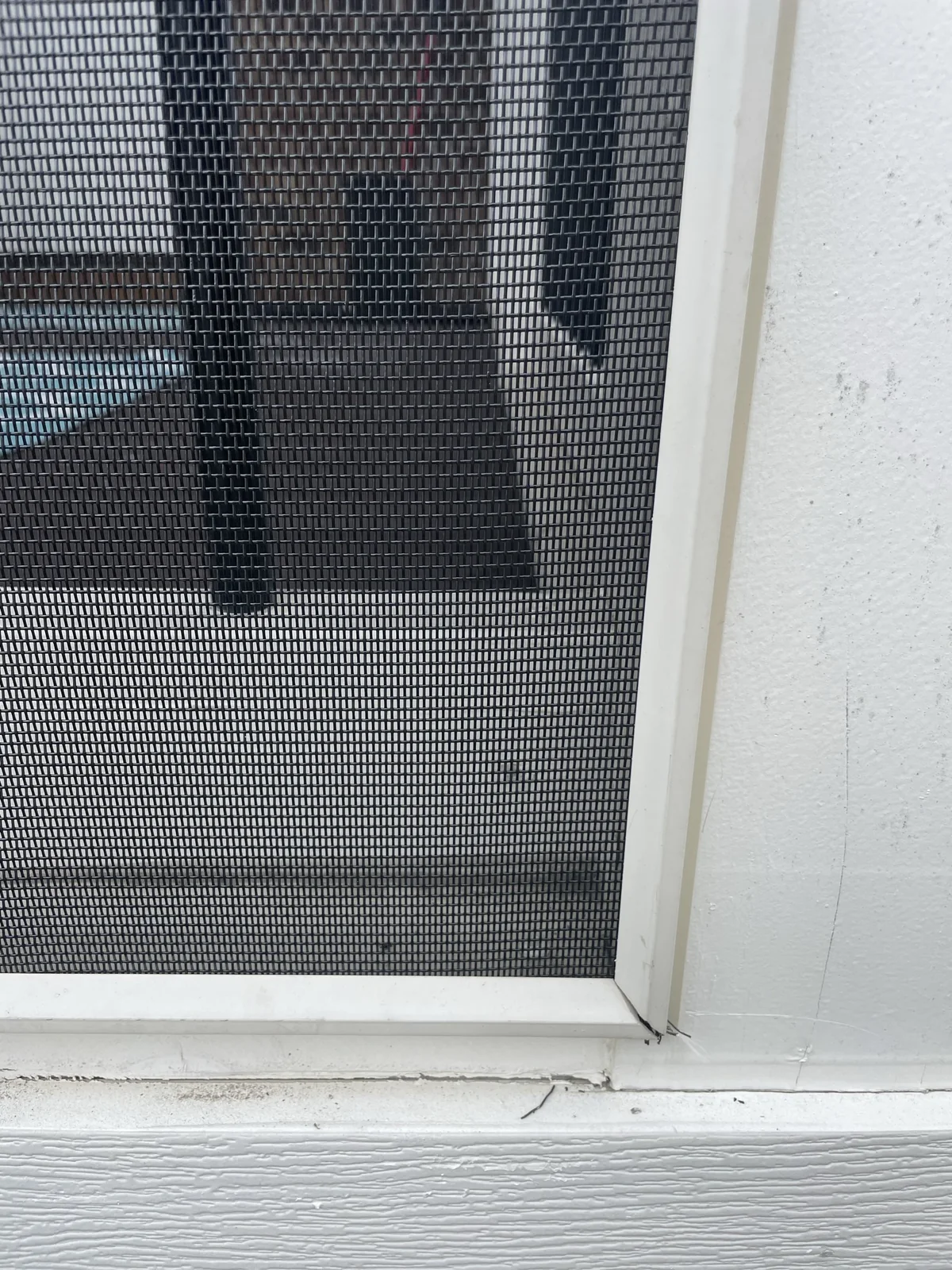 Close-up of screen mesh retained in an installed white SCREENEZE cap-and-base system.