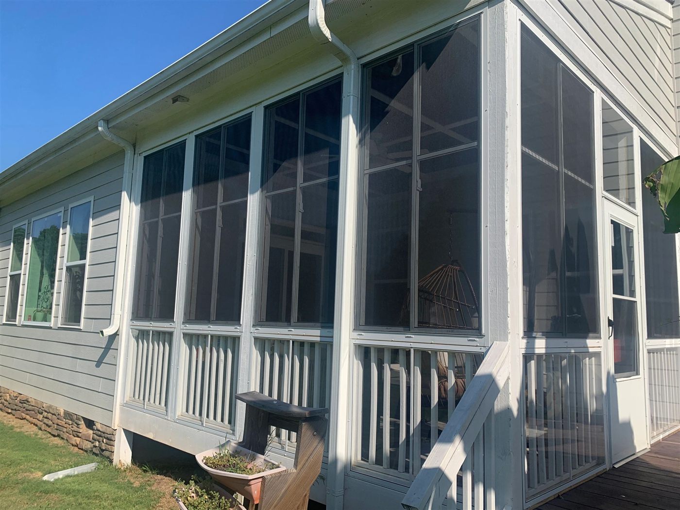 White Eze-Breeze SS10 horizontal sliders installed above existing porch rails.