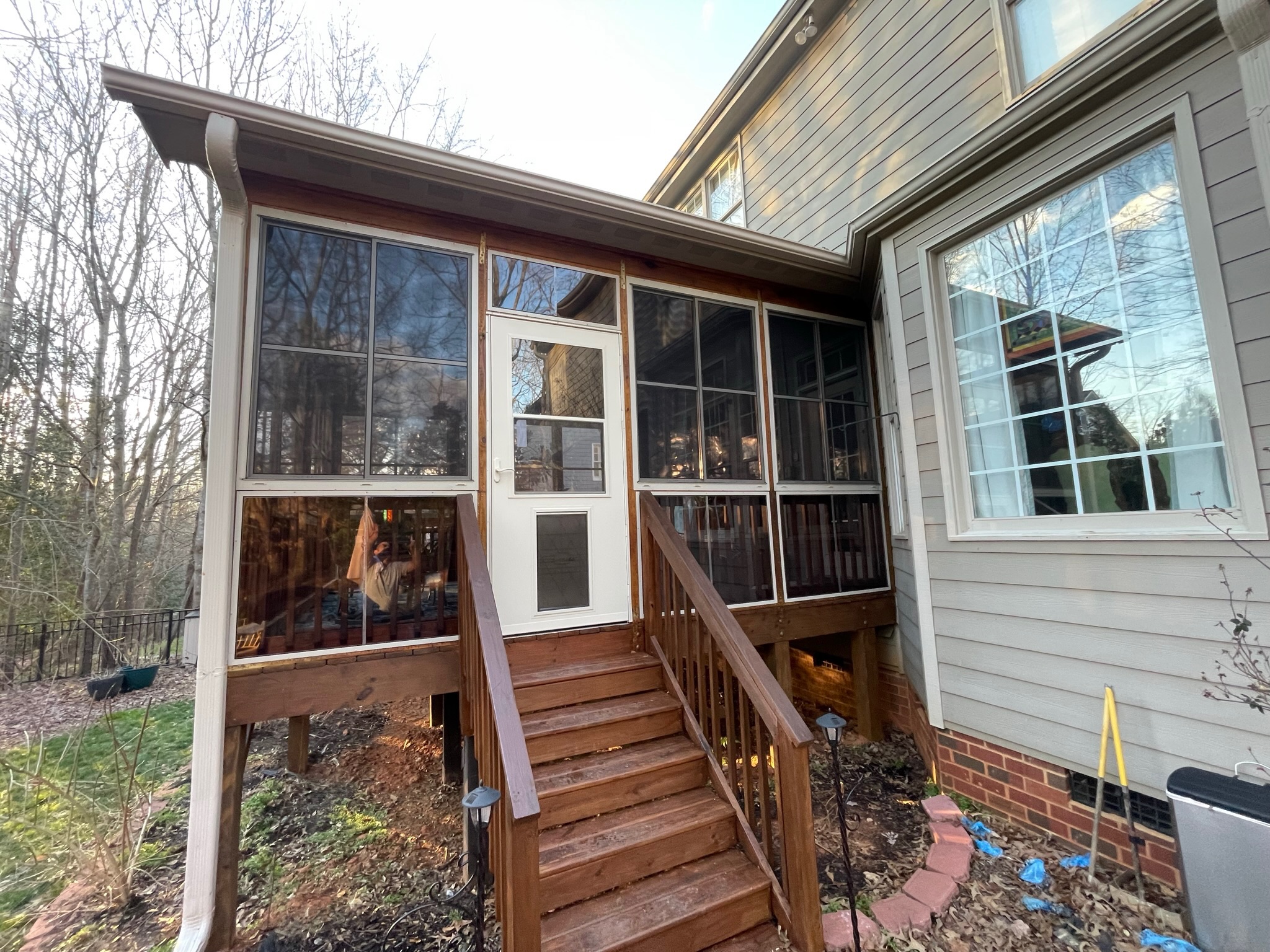 Almond Larson 20 Pet Highview storm door installed in a porch enclosure.