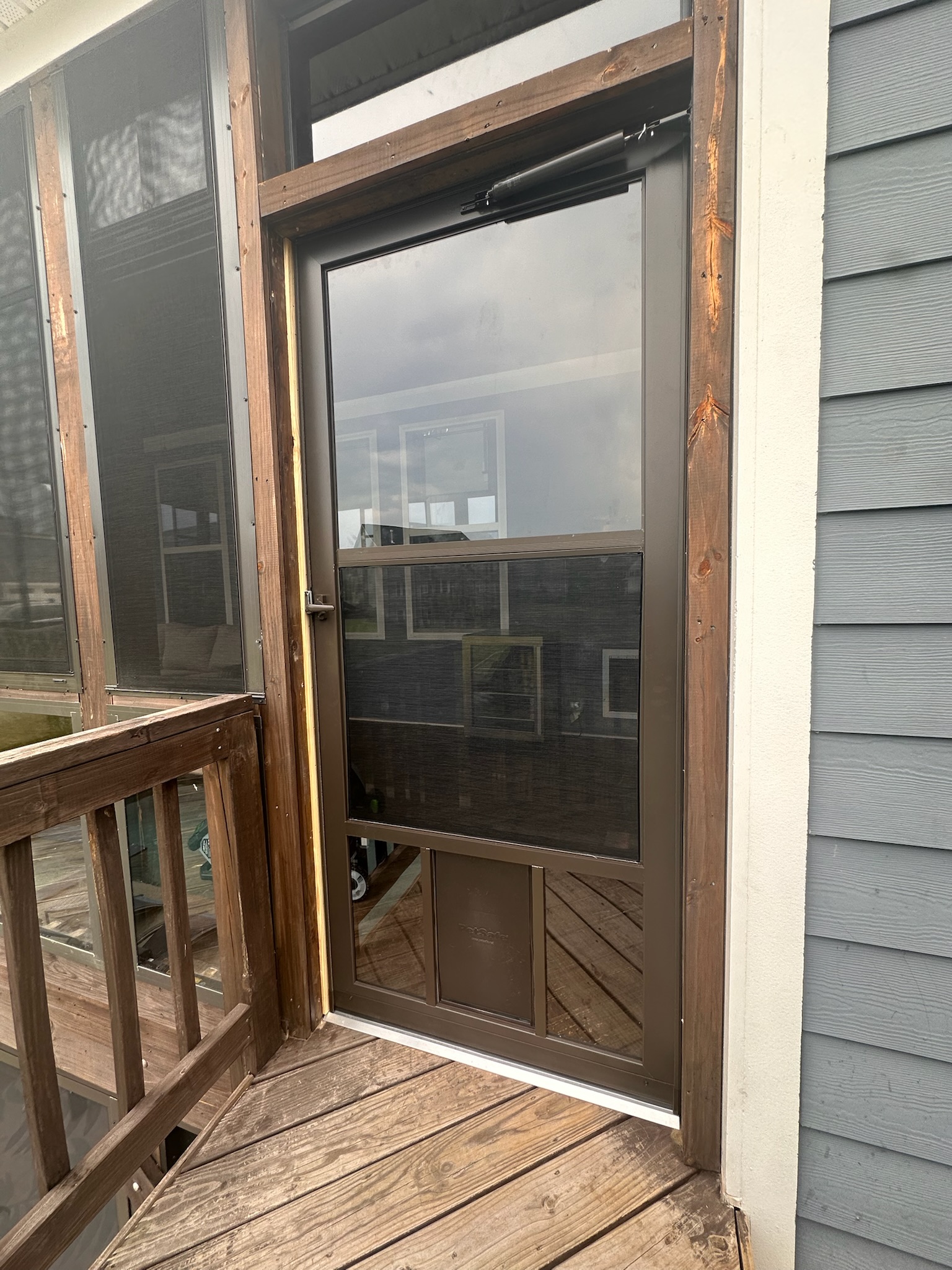Bronze Larson 25 Pet Fullview storm door with a large integrated pet door.