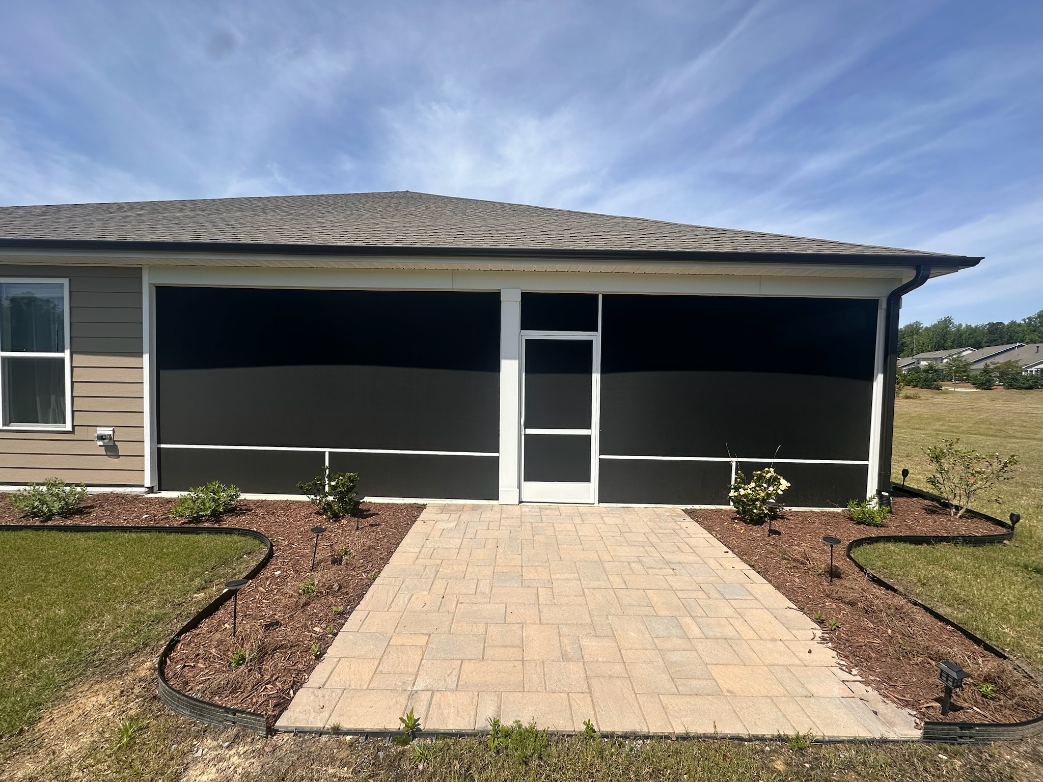 SunTex 90 solar screen installed in white extruded-aluminum porch framing.