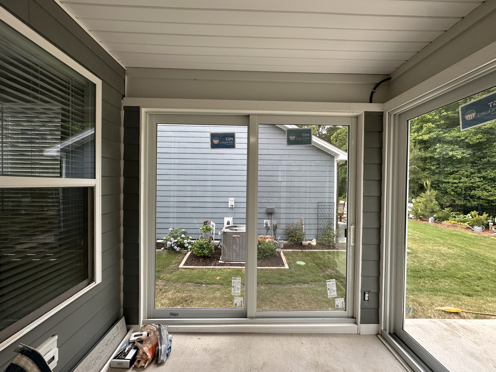 Interior view of a white two-track, two-panel PGT SGD770 sliding glass door.