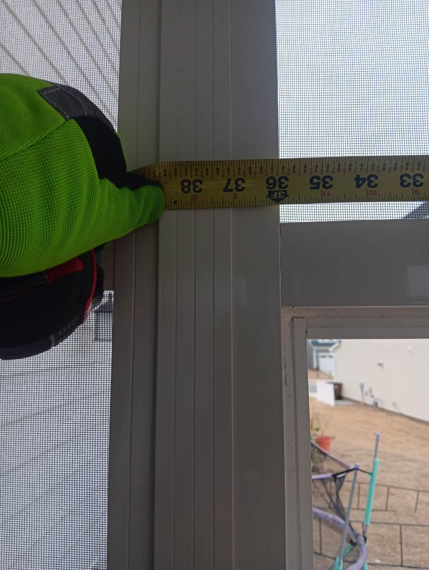 Best Screens team member measuring a porch opening