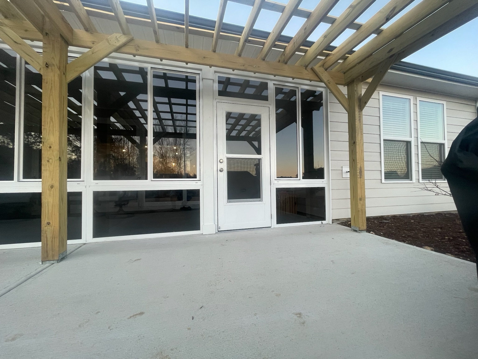 Completed CWS glass porch enclosure with side-sliding windows and fixed lower glass panels.