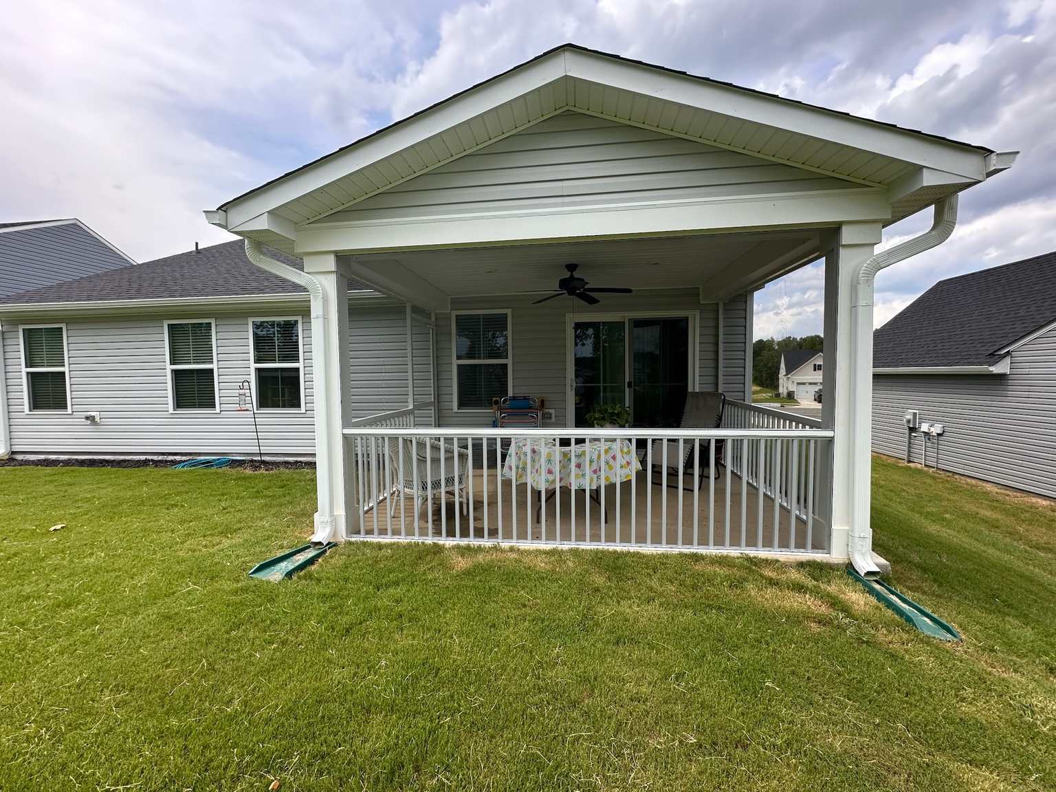 Completed extruded-aluminum porch enclosure with integrated pickets.