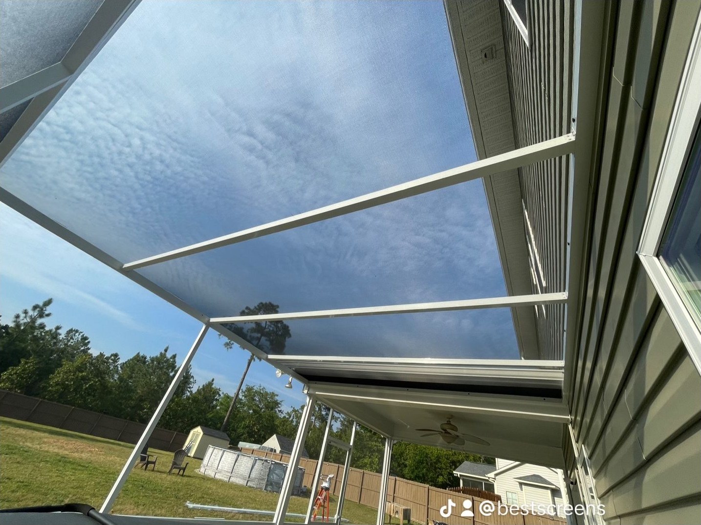 Extruded-aluminum screen-roof enclosure viewed from underneath the overhead mesh.