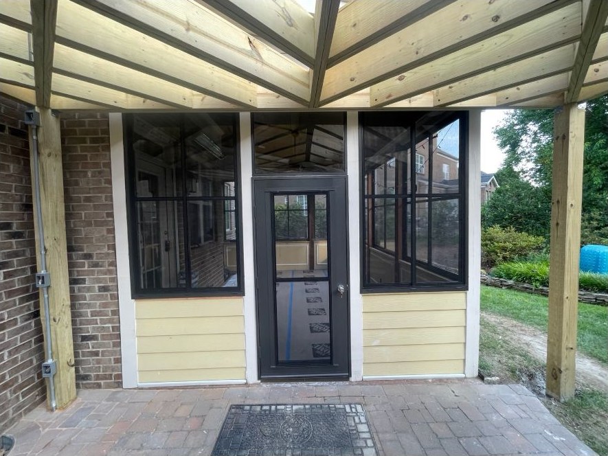 Bronze Eze-Breeze SS10 horizontal sliders installed on a porch enclosure.