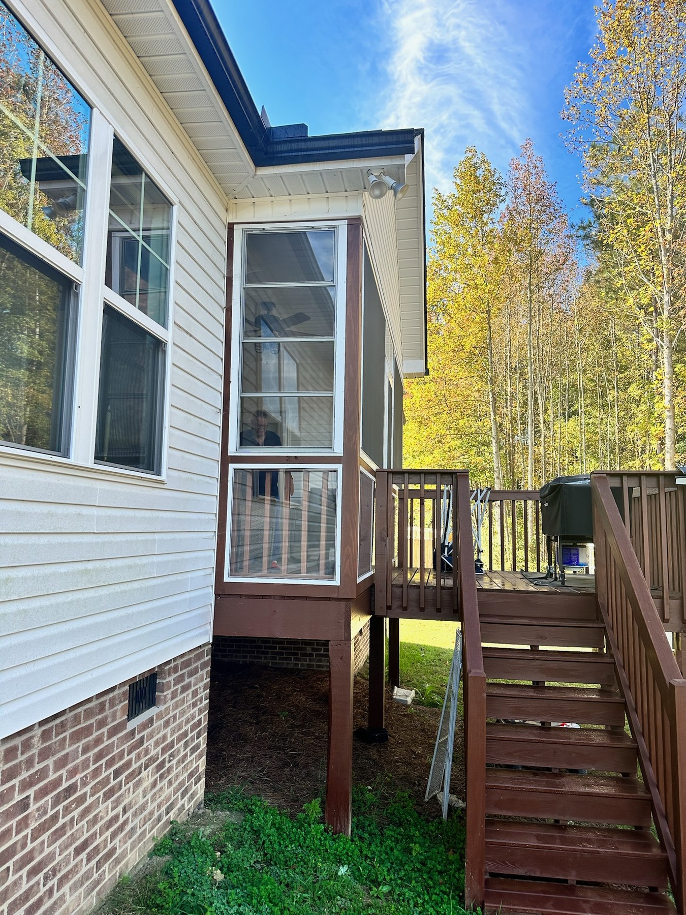 White Eze-Breeze 4V60 vertical slider above a porch rail with an LF20 fixed panel below.
