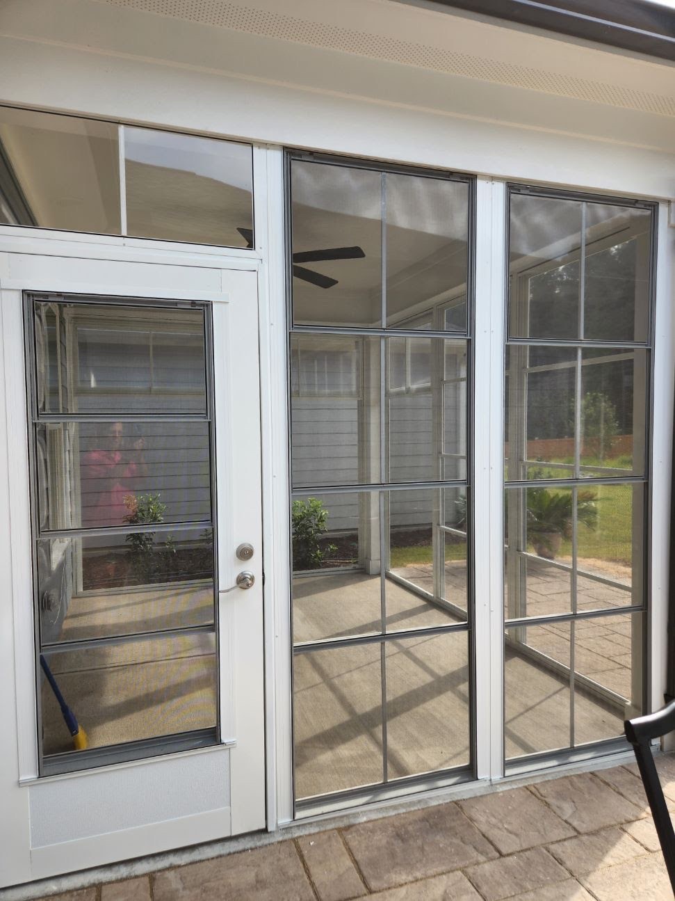 White Eze-Breeze porch with a CD90 door, LF20 transom and adjacent 4V60 vertical sliders.