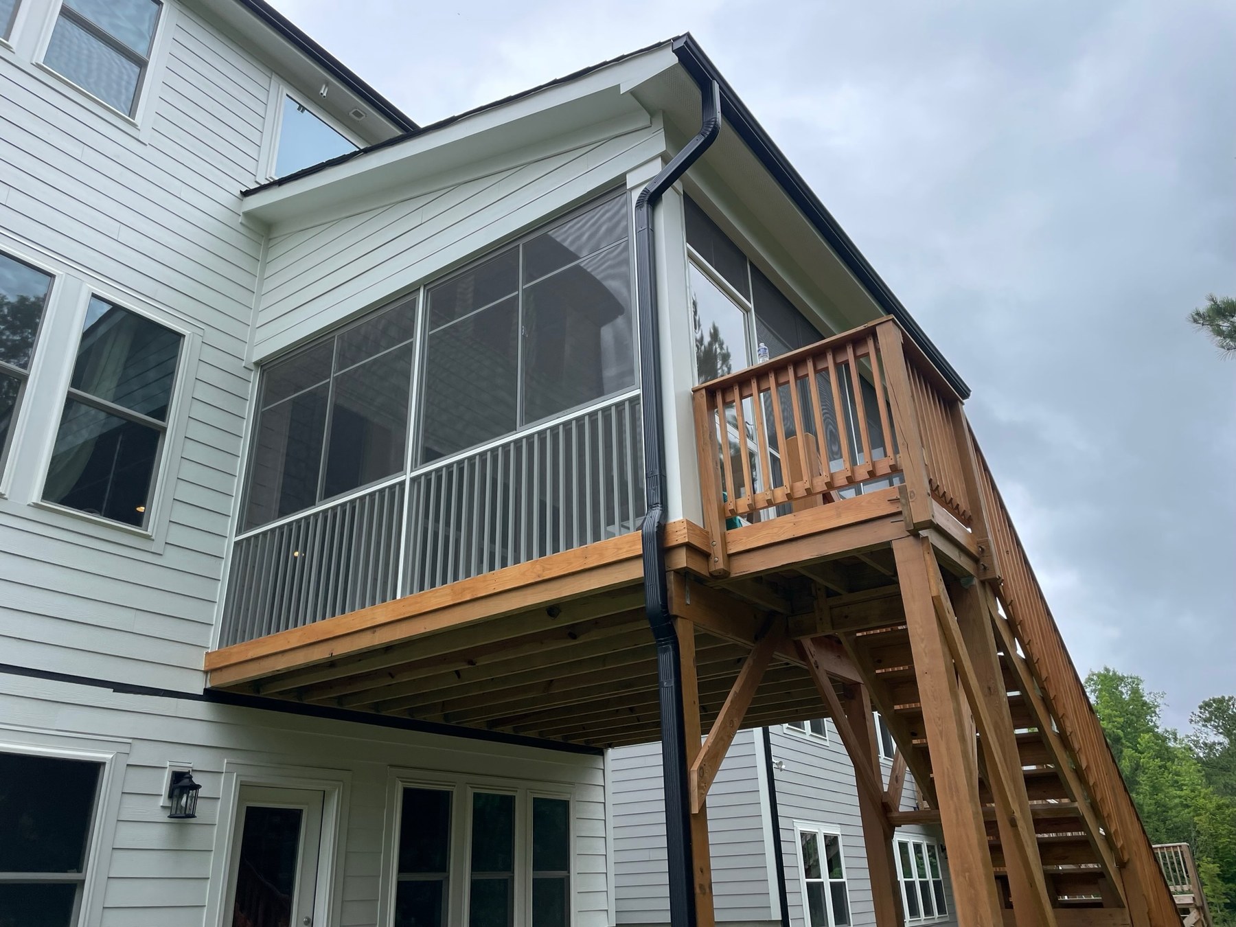 White Eze-Breeze SS10 horizontal sliders above a porch rail with LF20 fixed panels below.
