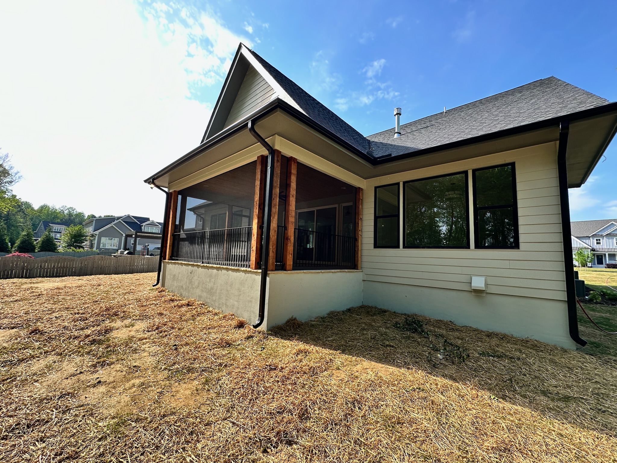 Black ARC perimeter framing installed around an existing porch railing.