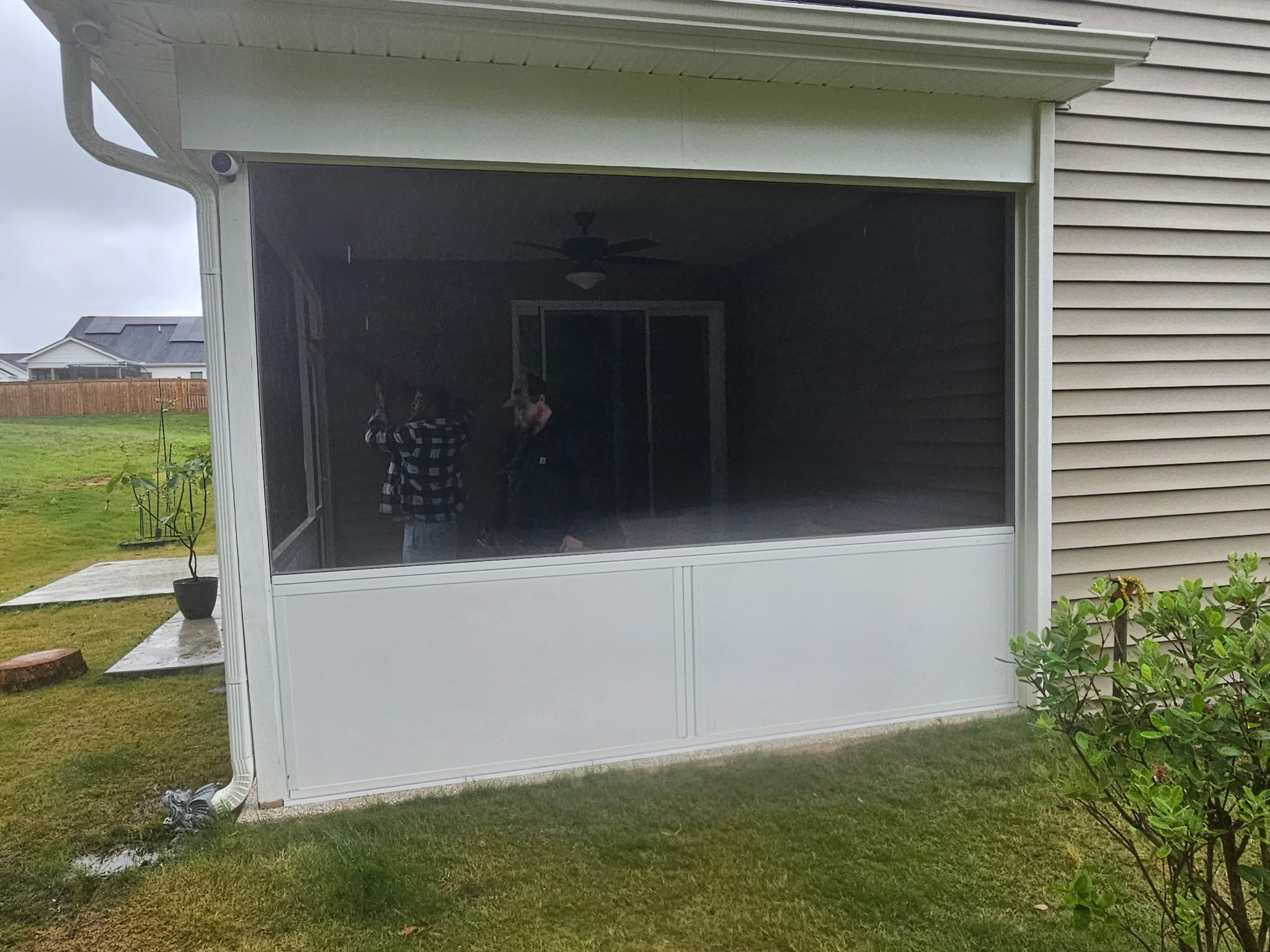 White extruded-aluminum screen enclosure with insulated-panel knee walls matching the framing depth.