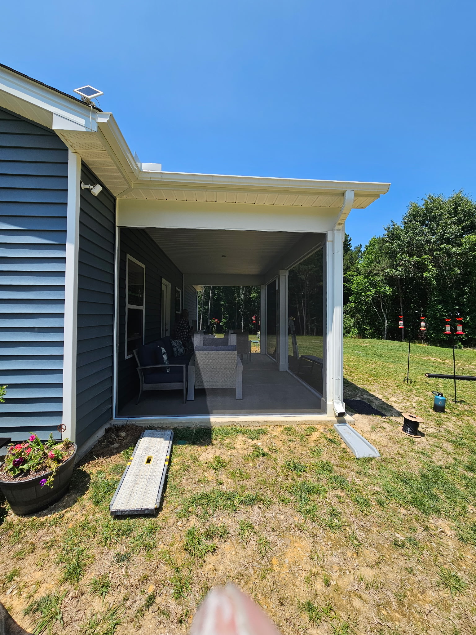 White extruded-aluminum screen porch with an open-view layout and no added rail or intermediate post.