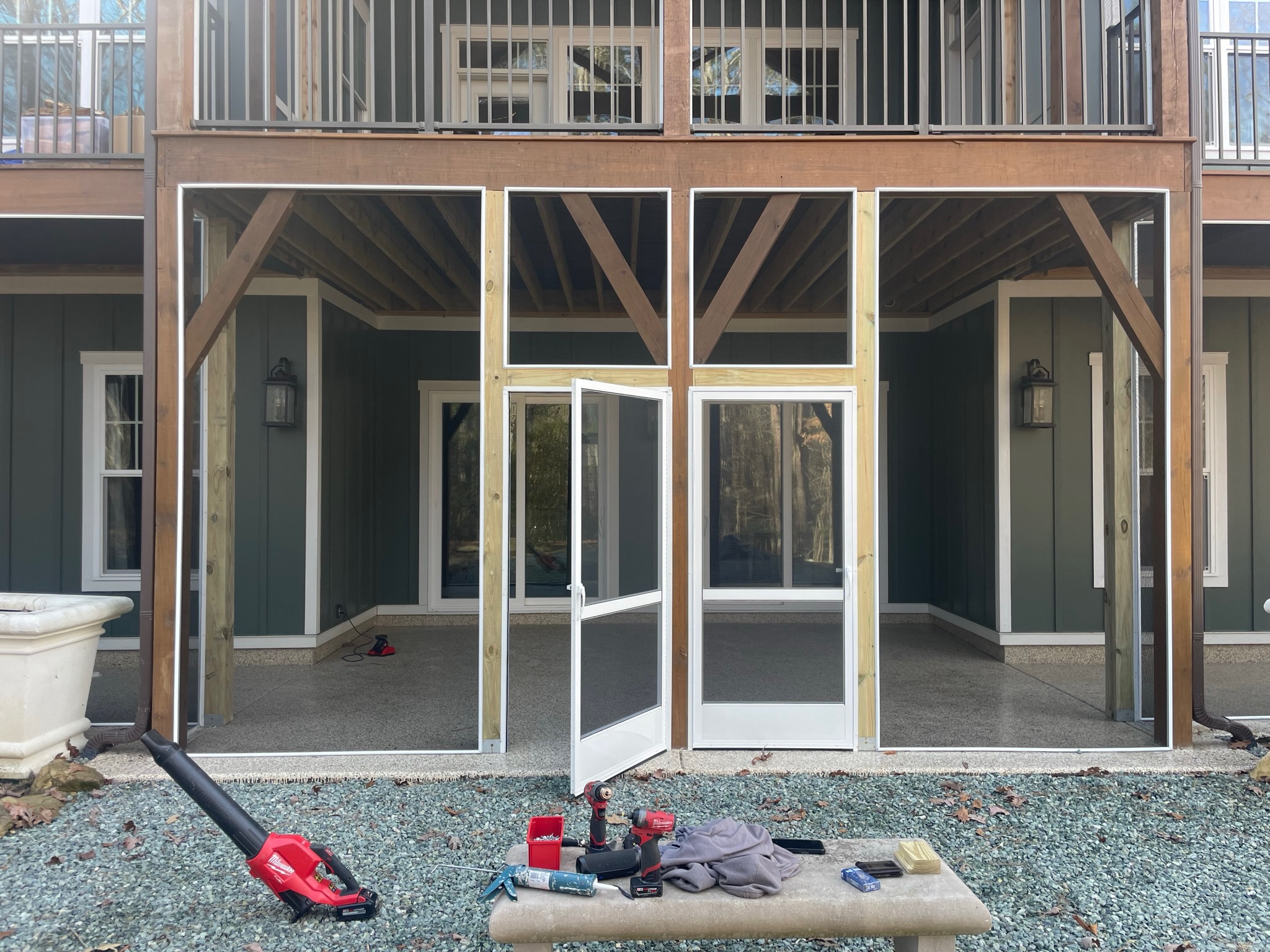 Under-deck outdoor living area enclosed with ScreenEZE.