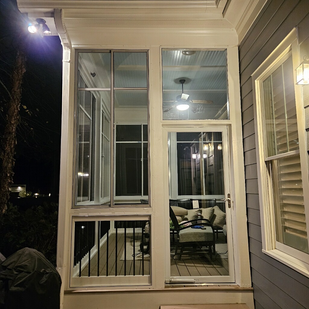 White Andersen 2000 self-storing storm door installed as an in-swing door beside SS10 and LF20 panels.