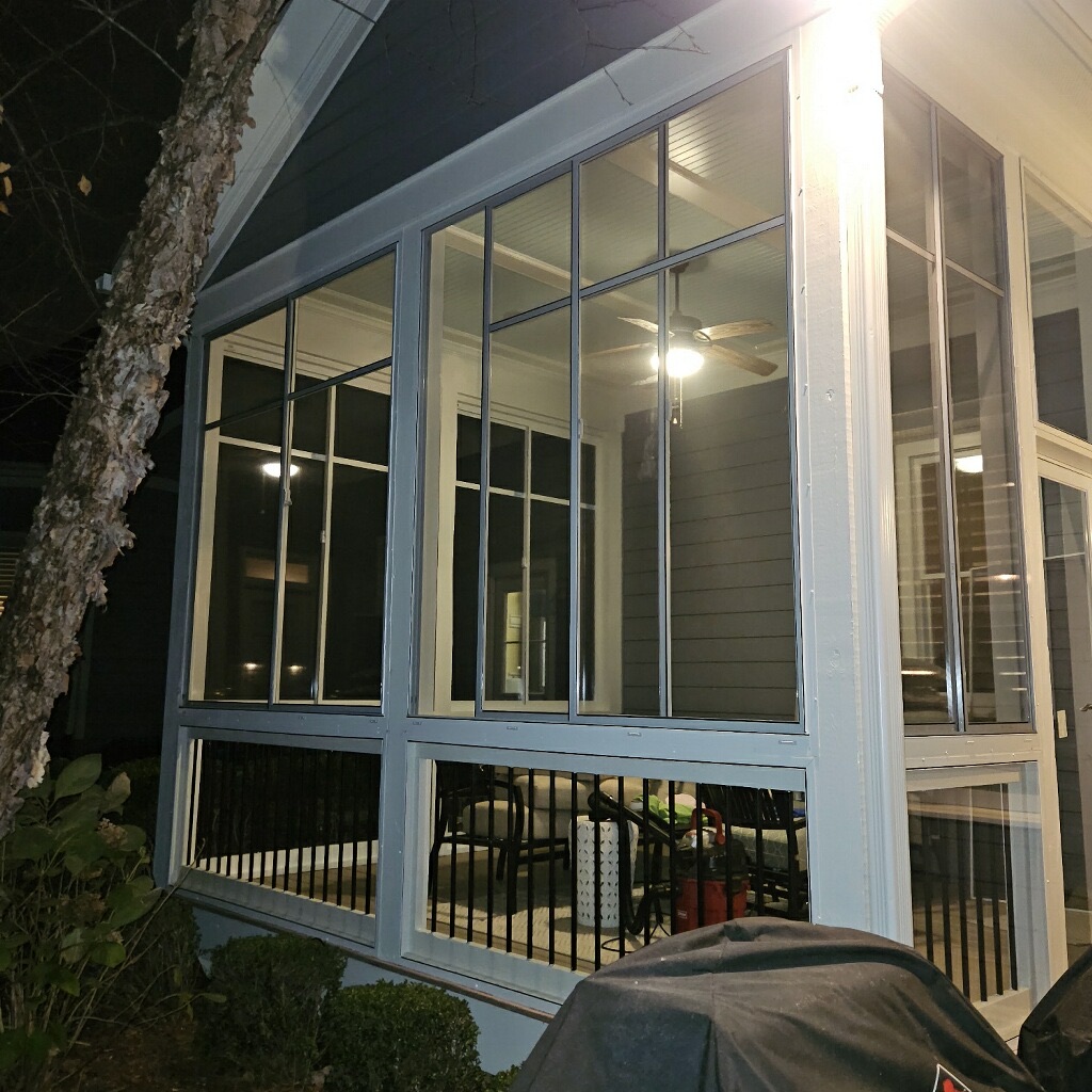 Side exterior view of white Eze-Breeze SS10 horizontal sliders with clear polyvinyl above LF20 fixed panels.
