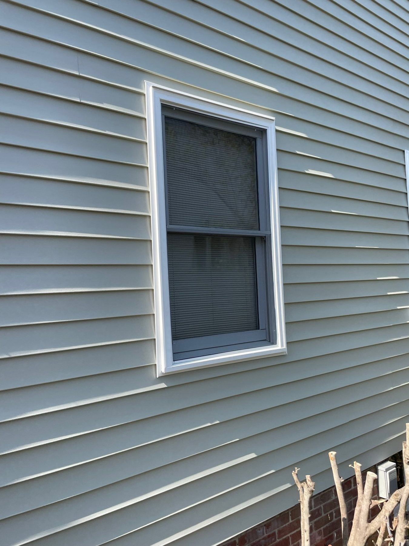 Full window screen covering both sash areas of a residential double-hung window.