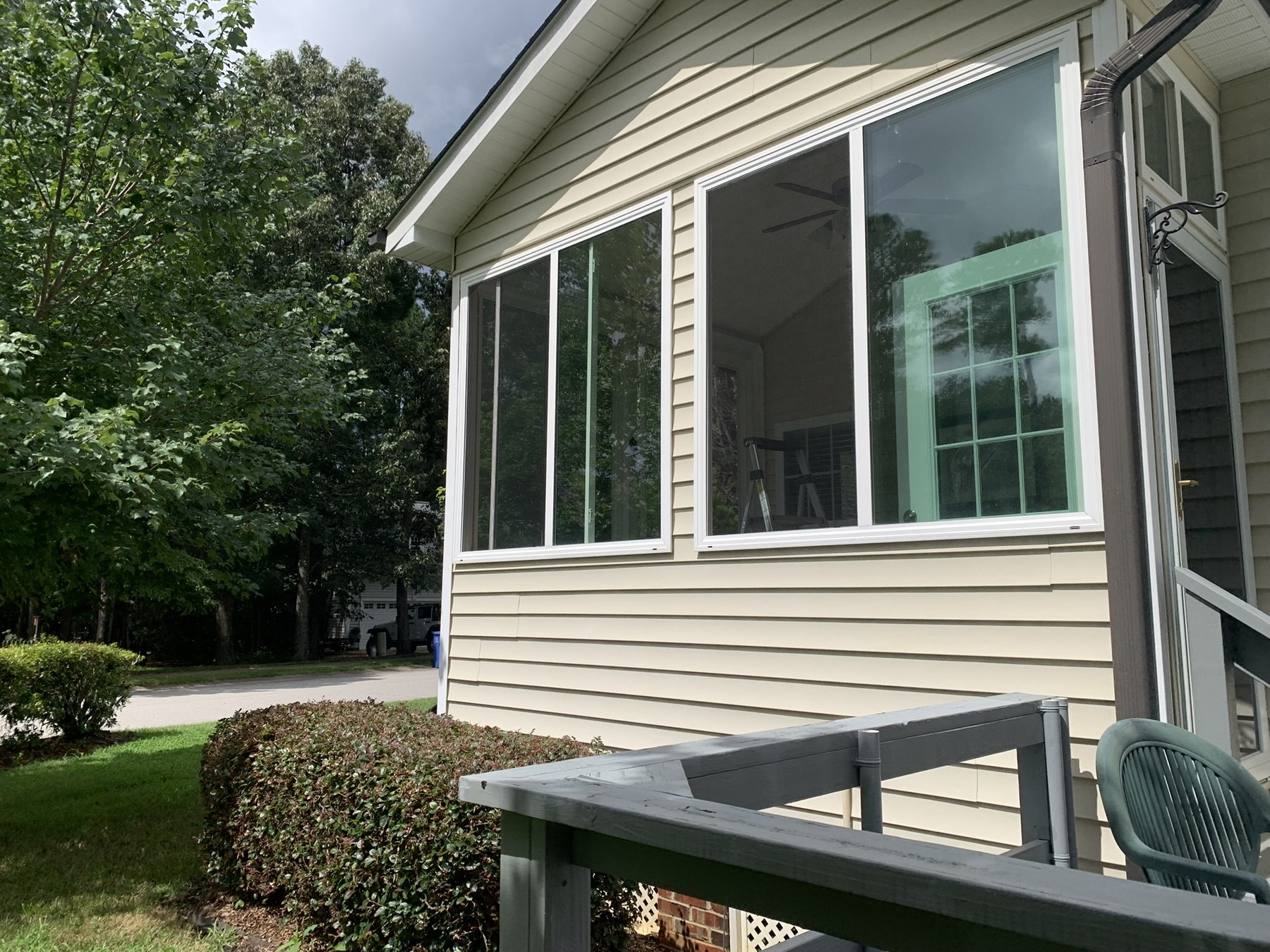 Window screens fitted over the operable sides of residential side-slider windows.